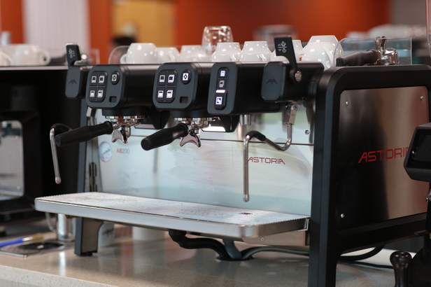 Astoria espresso machine featuring sleek controls, ready for crafting perfect coffee in a modern café setting.