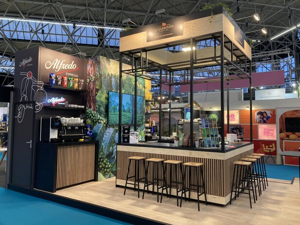 Stijlvolle koffiestand met Alfredo Espresso met barkrukken, koffieproducten en een levendige achtergrond.