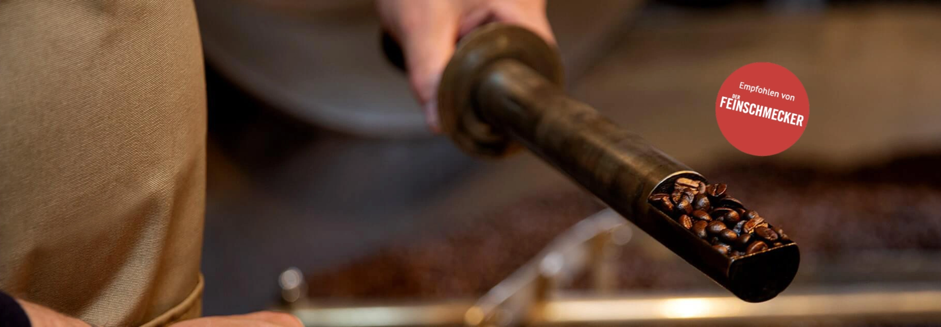 Freshly roasted coffee beans being poured from a roasting tool, showcasing a passion for quality coffee preparation.