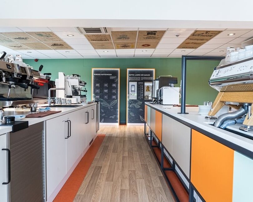 Modern coffee bar setup featuring espresso machines and brewing equipment in a bright, inviting café space.