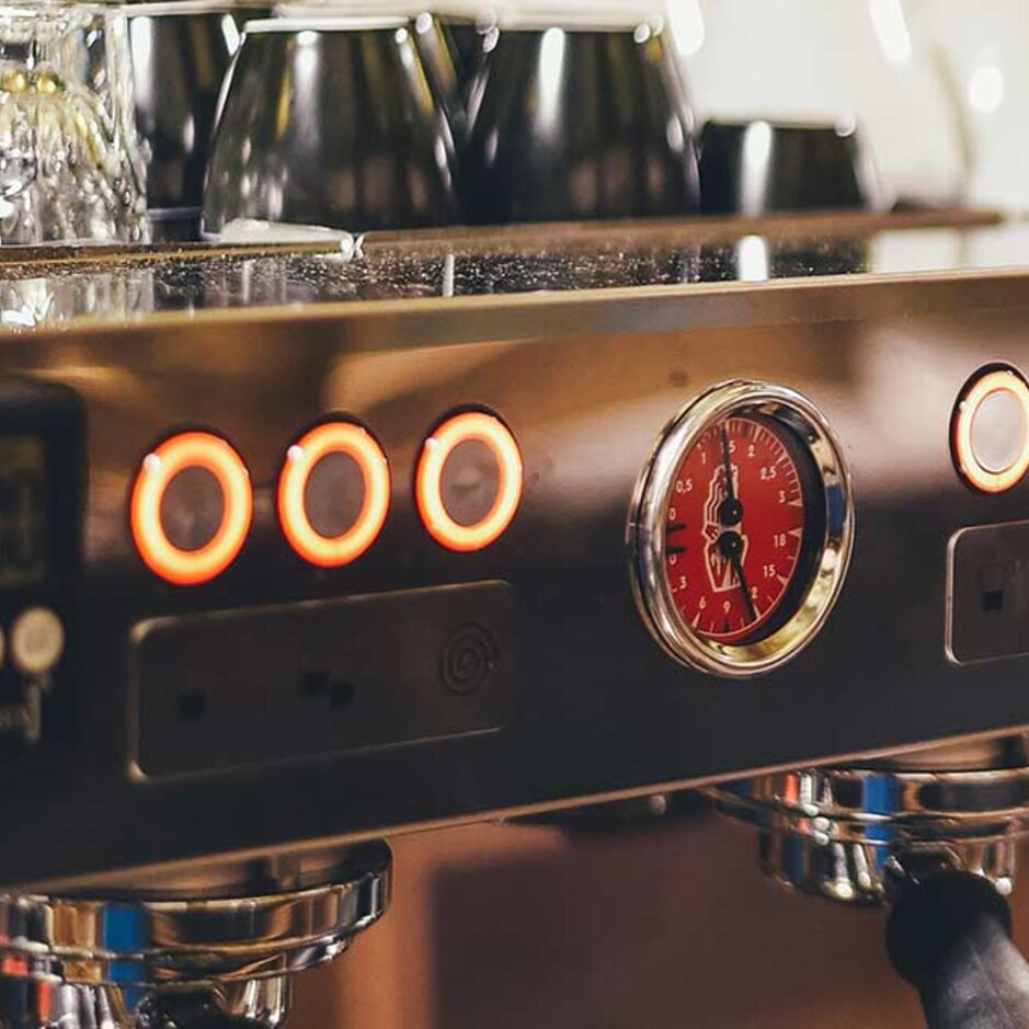 Professional coffee machine controls featuring an intricate gauge, ideal for gastronomy and café enthusiasts.