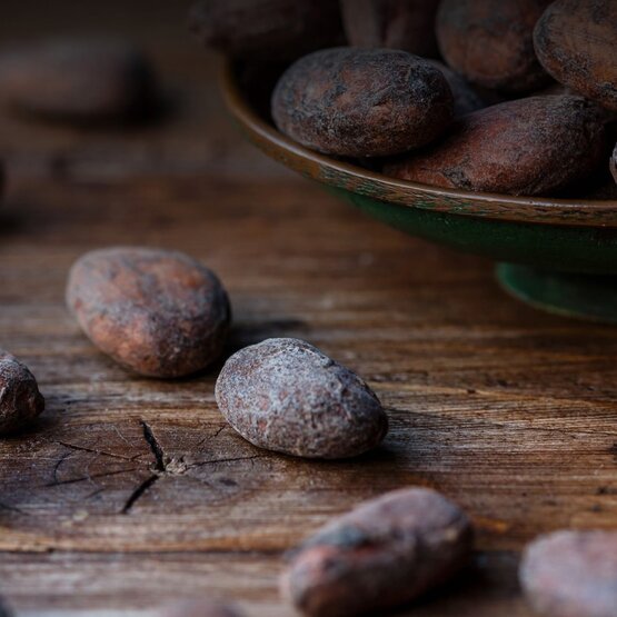 Close-up of cocoa beans on a wooden table.